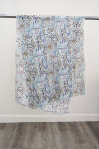 A large silk scarf with a blue, pink, and green paisley pattern displayed on a metal rod against a white background, front view