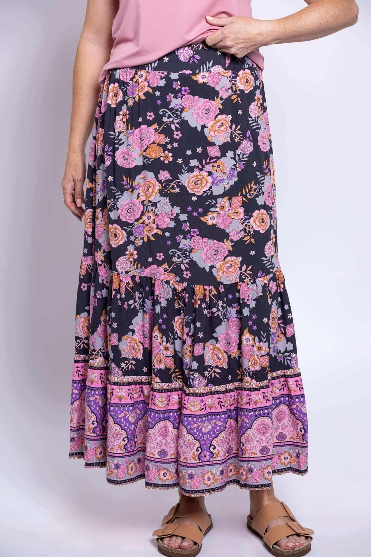 Detail view of ankle-length tiered skirt with pink and purple floral patterns