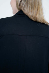 Close-up of the back collar and yoke stitching on the black duster