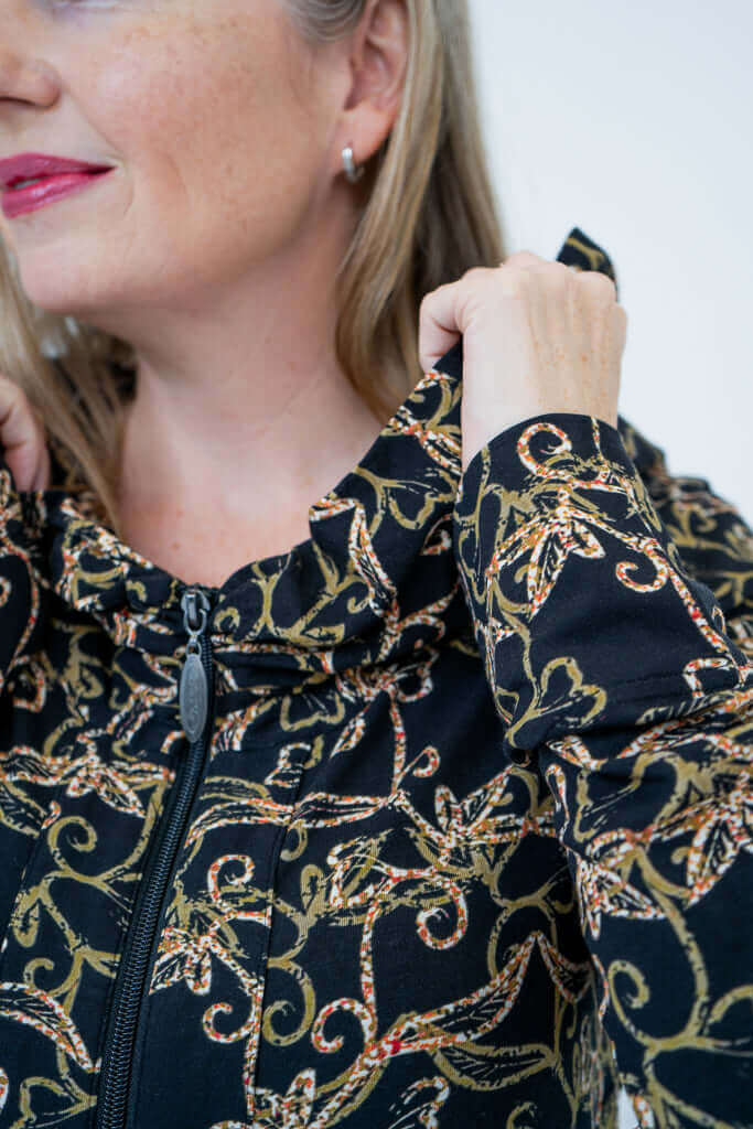 Close-up of collar and zipper detail on vine print hooded jacket