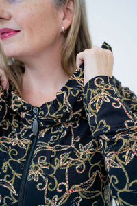 Close-up of collar and zipper detail on vine print hooded jacket