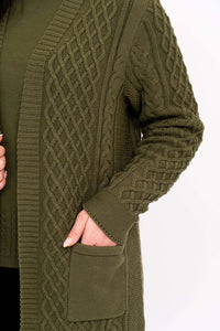 Close-up of the olive green cable knit cardigan's textured sleeve and patch pocket