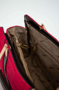 Detailed inside view of crimson satchel bag highlighting zippered pockets and WENZ lining