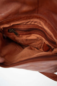Detailed view of bag interior with zippered pocket and card slots