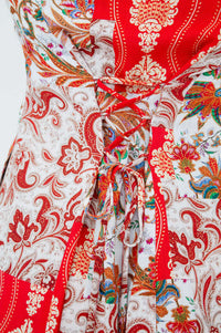 Close-up of the adjustable corset tie detail on the back of a paisley dress