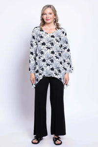 Full front view of model in Dorothy black and white floral top paired with black pants