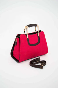 Elegant crimson satchel bag with gold hardware and adjustable black strap