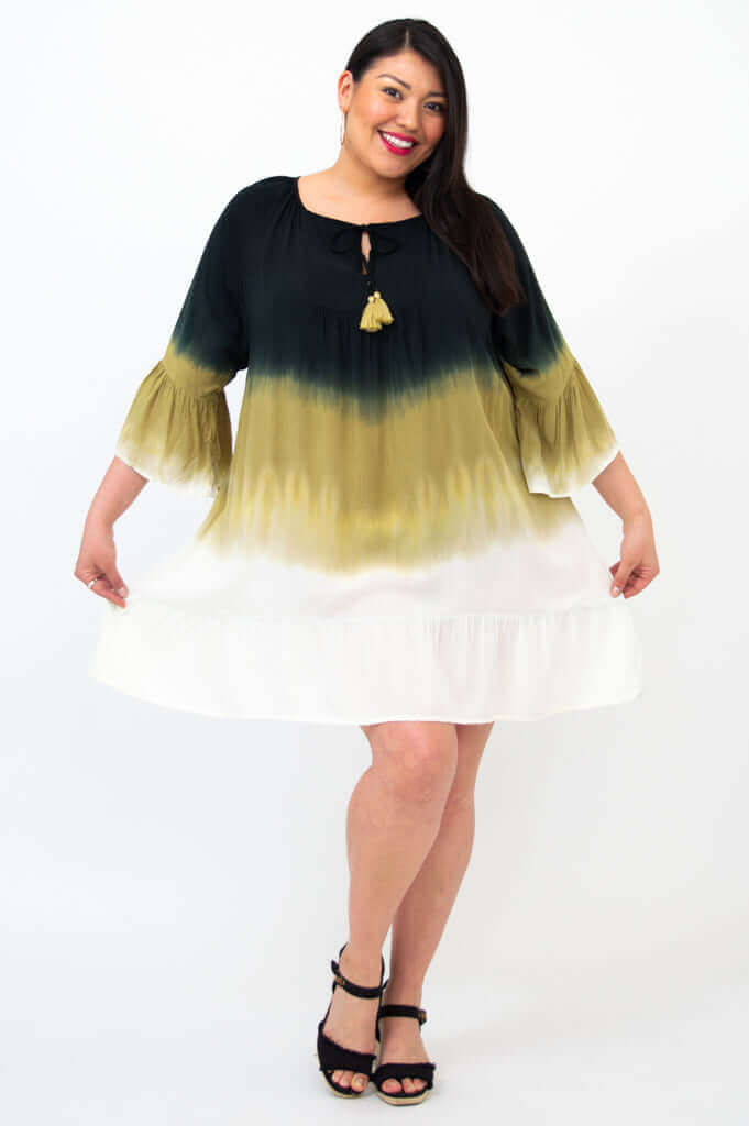 Playful pose in the Ellie Dress, displaying the flounced hem and lightweight style