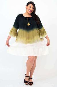 Playful pose in the Ellie Dress, displaying the flounced hem and lightweight style