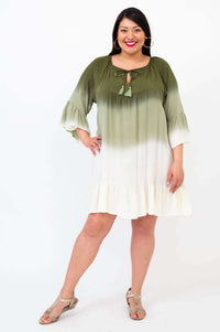 Front view of model wearing olive ombre Ellie Dress with ruffle hem and tie neck detail