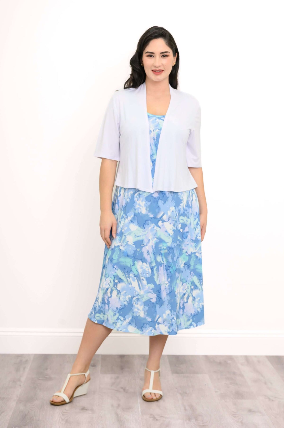 Front view of model in blue watercolor tank dress paired with a light cover-up