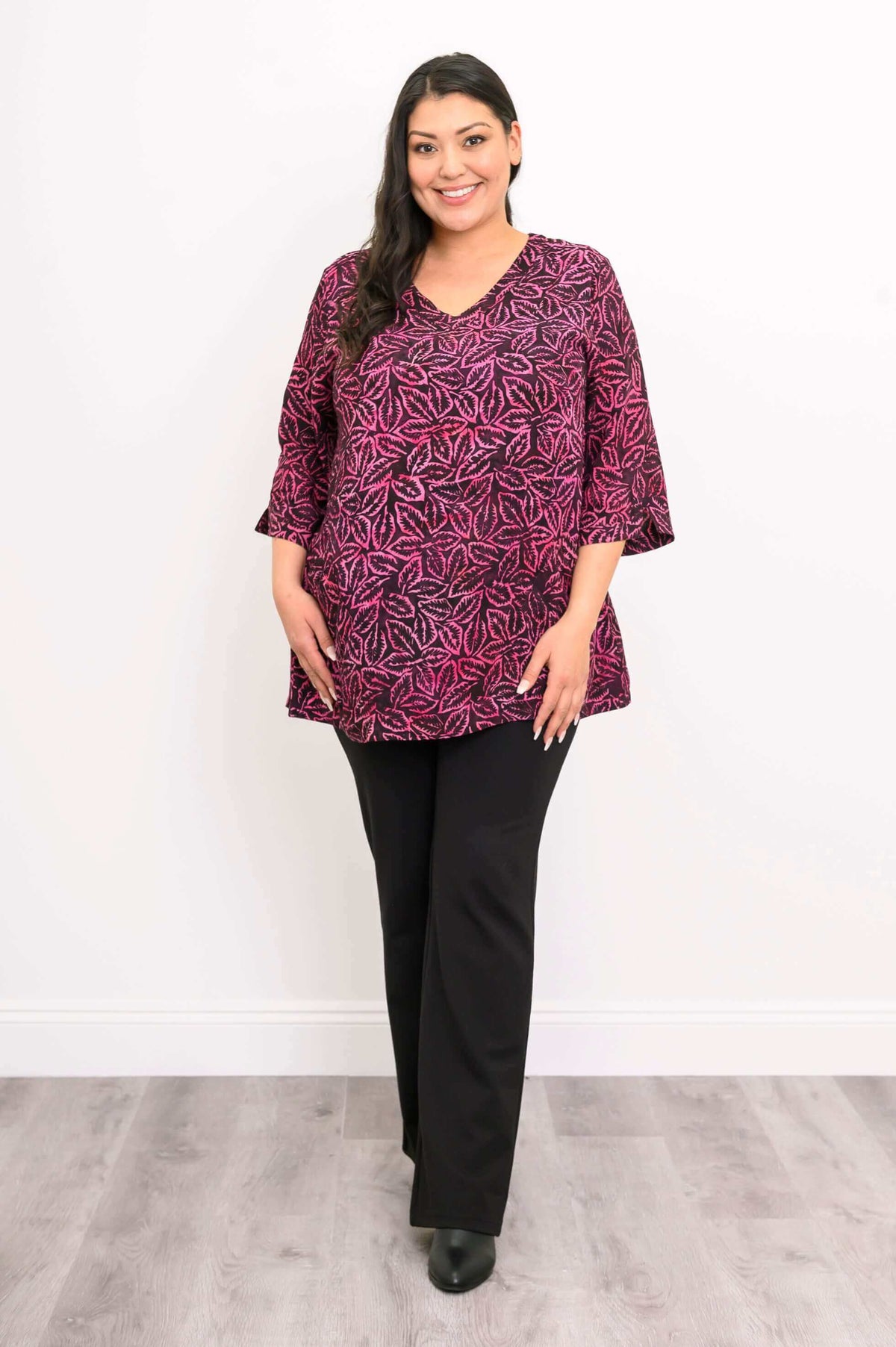 Woman in Evelyn Top and black pants standing with hands at sides, front view