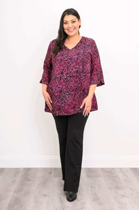 Woman in Evelyn Top and black pants standing with hands at sides, front view