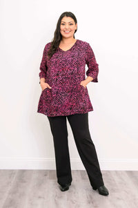 Woman standing with hands in pockets wearing Evelyn Top and black pants
