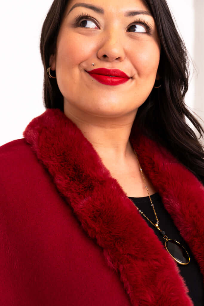 Close-up of faux fur collar on scarlet wrap