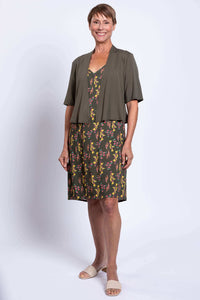 Woman in Felicia dress with open olive cardigan, full view