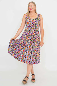 Model displaying the flared skirt of a colorful floral tank dress