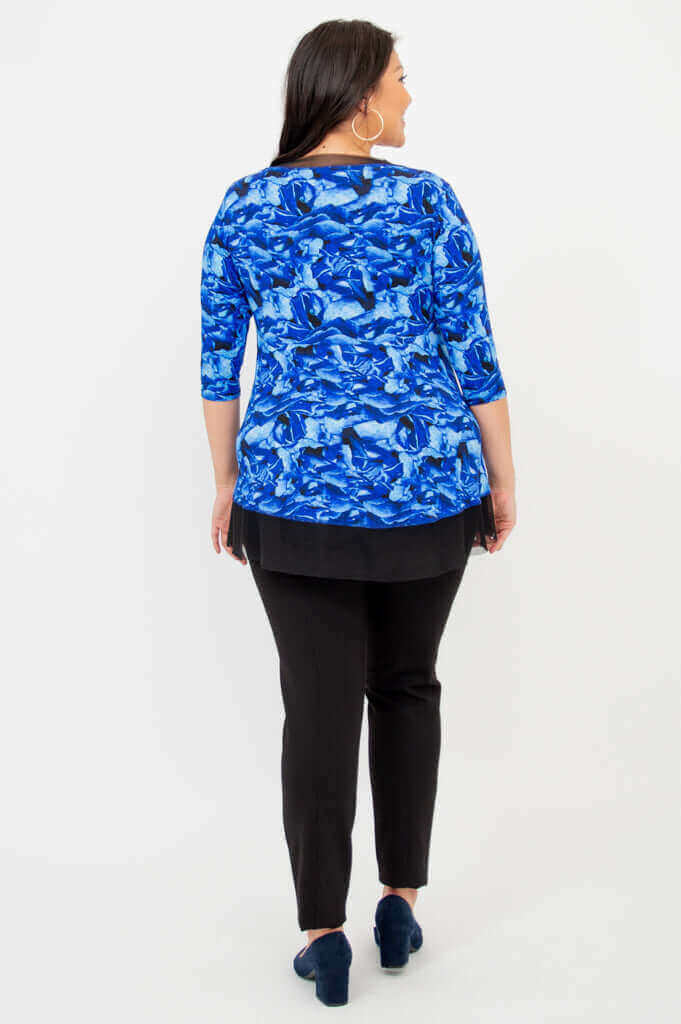 Back view of the Flora Top in Blue Rose showing the mesh hem and blue floral pattern