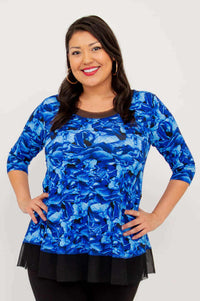 Front view of a woman wearing the Flora Top in Blue Rose with black mesh hem and 3/4 sleeves