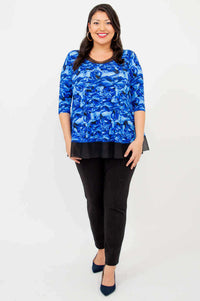 Full-length front view of a woman modeling the Flora Top in Blue Rose paired with black pants