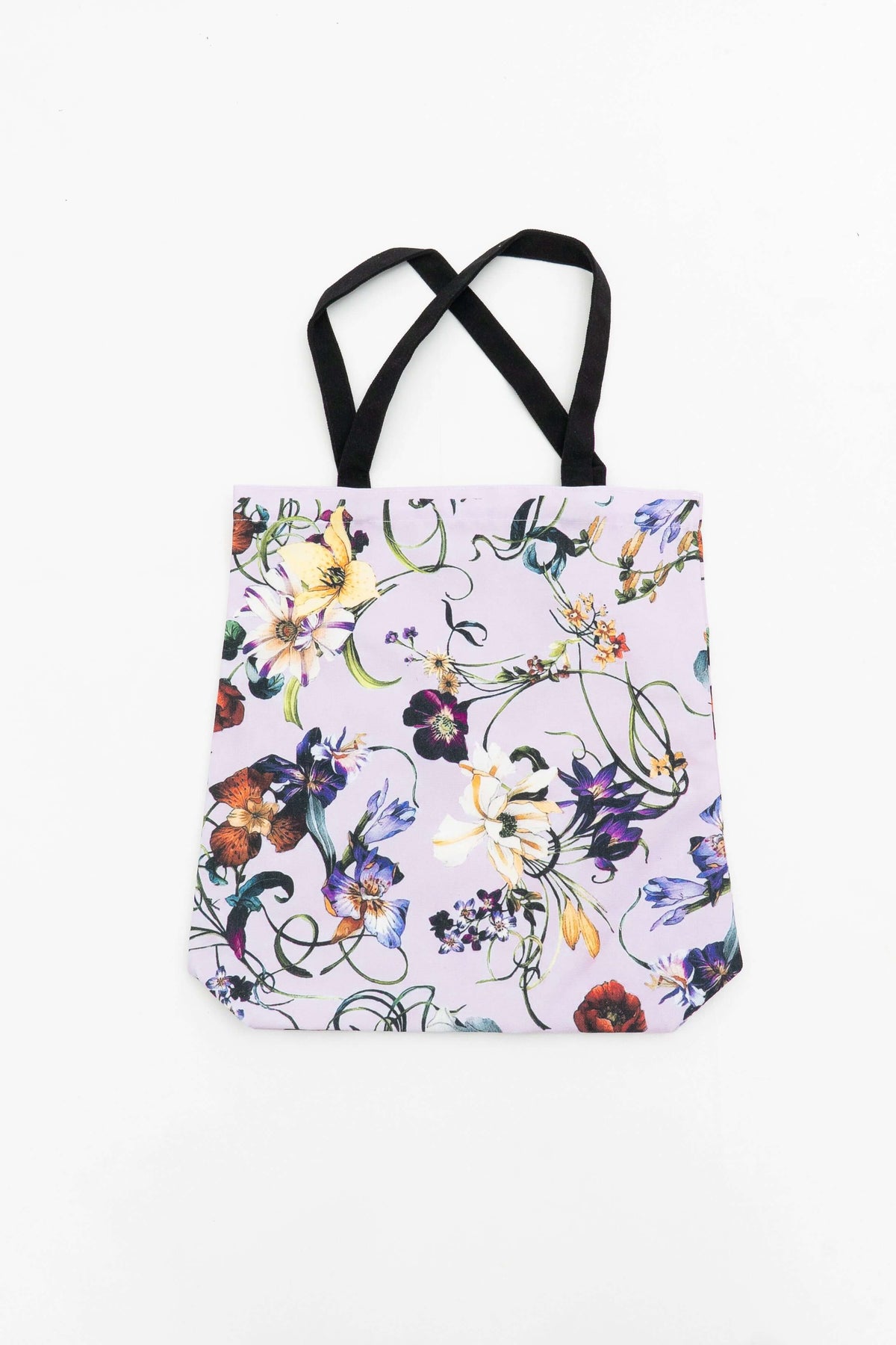Reusable cotton canvas tote bag with vibrant floral pattern and black handles