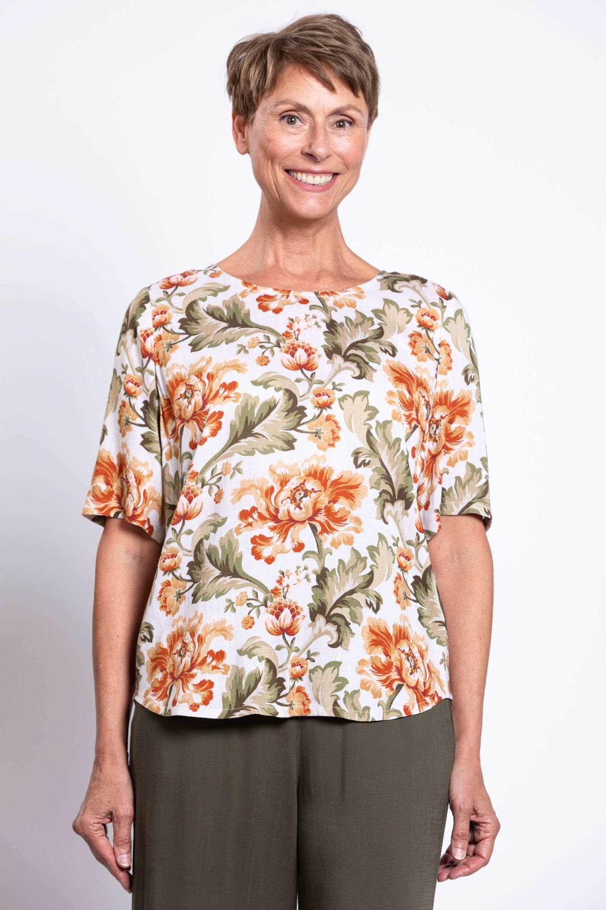 Front view of woman wearing a floral bamboo-linen blouse with elbow length sleeves