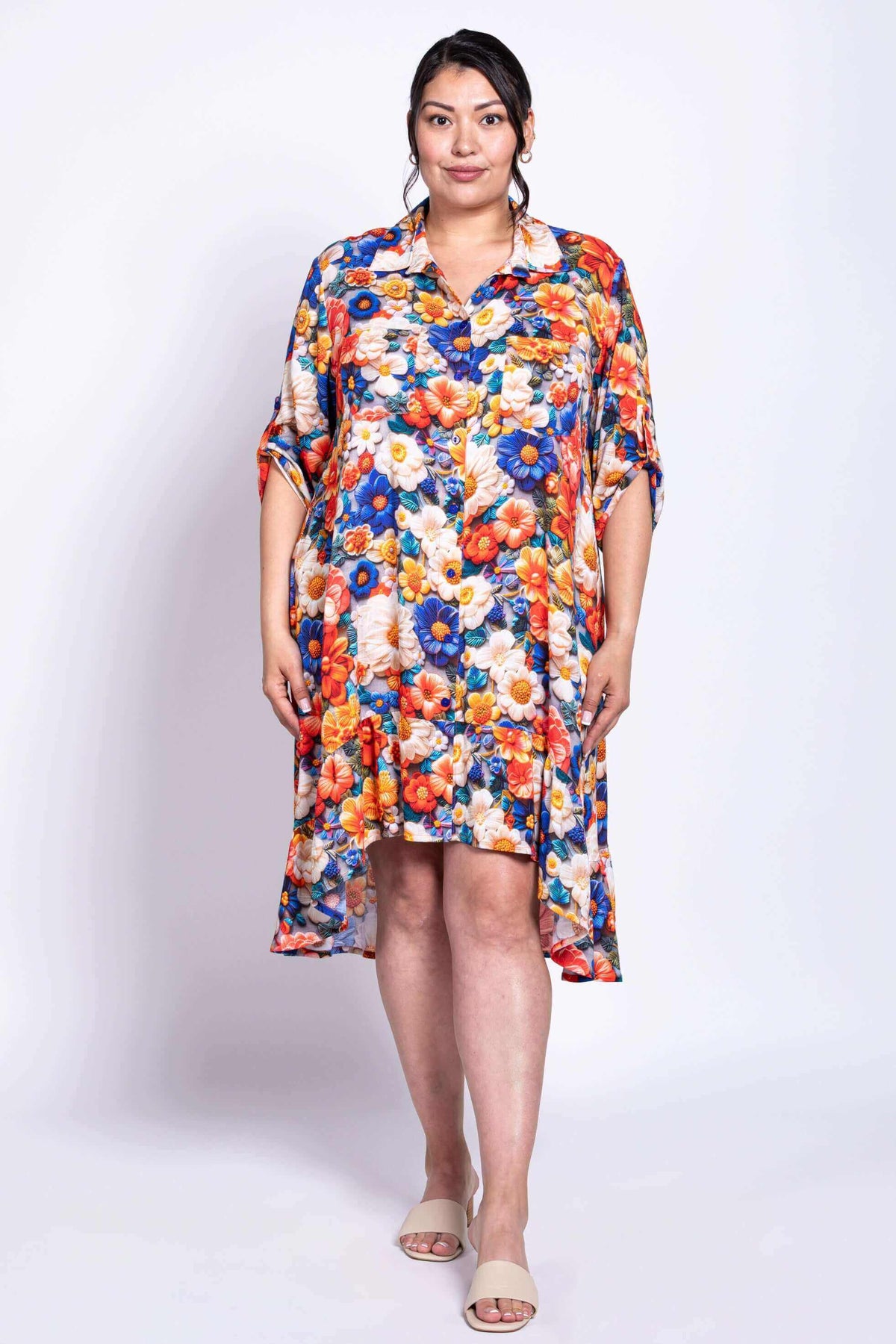 Model standing in a vivid floral dress with shirt collar and button-up front