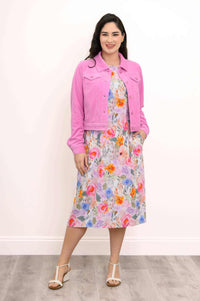 Floral shift dress styled with a bright pink jacket and white sandals