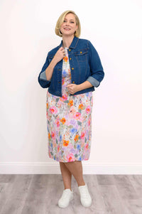 Floral shift dress styled with a denim jacket and white sneakers