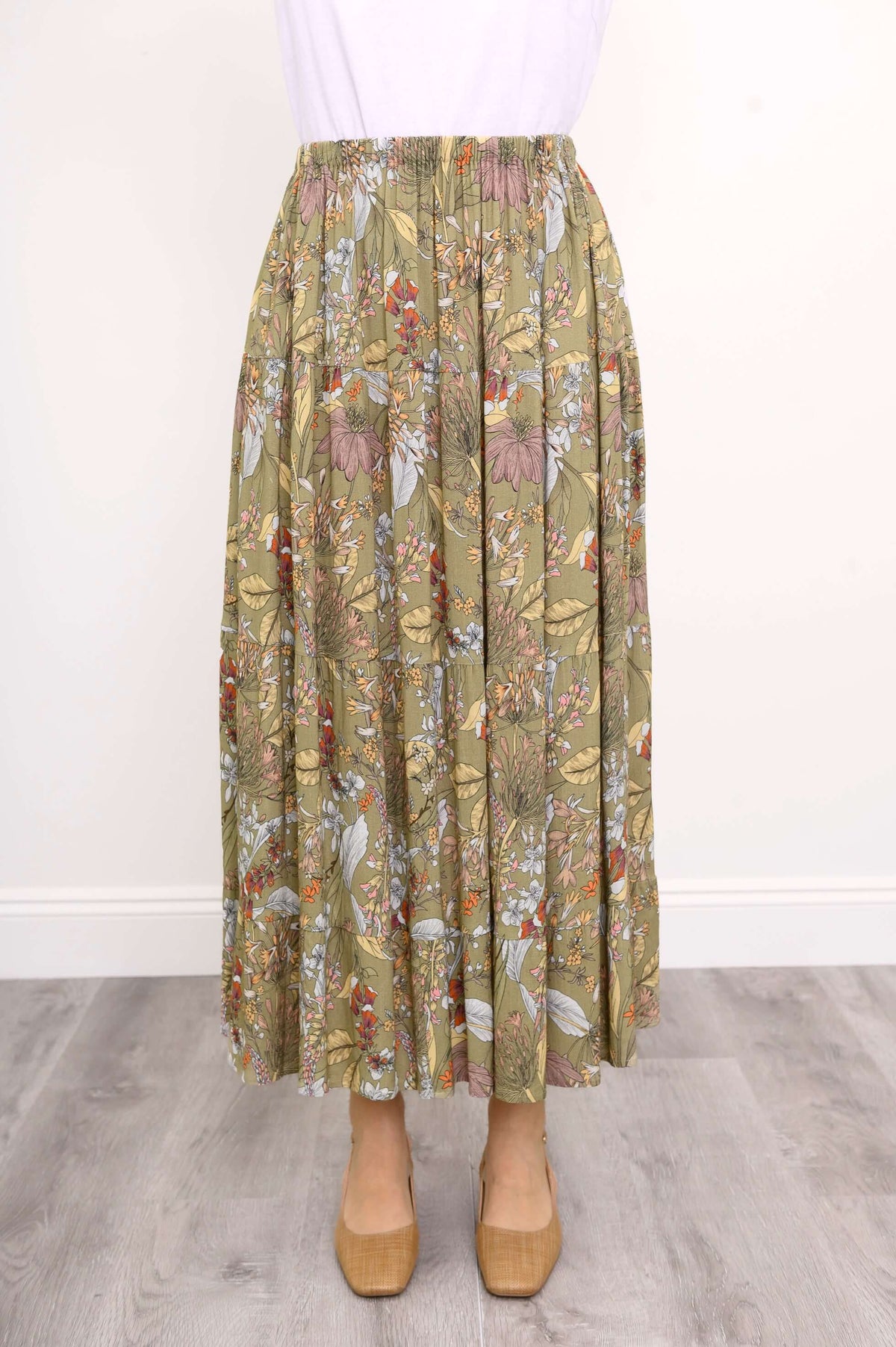 Close-up front view of a floral tiered maxi skirt with elastic waistband