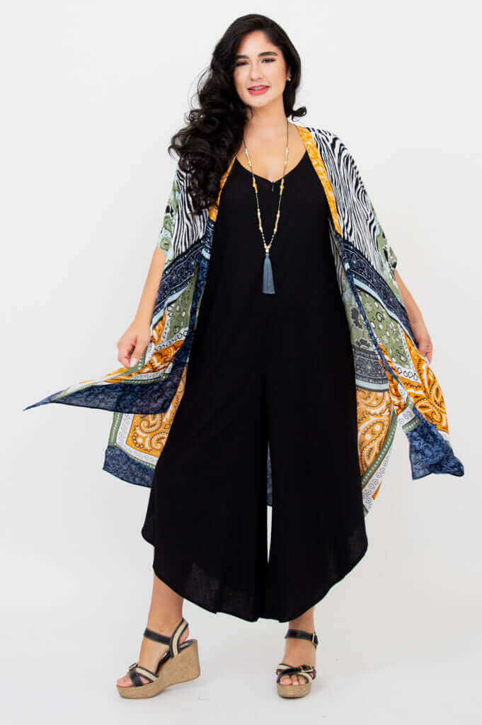 Woman spreading arms to show flowing Darcy kimono wrap patterns, front view