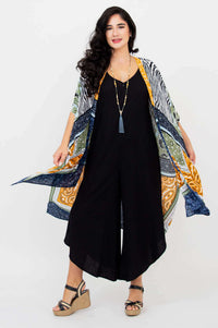 Woman spreading arms to show flowing Darcy kimono wrap patterns, front view