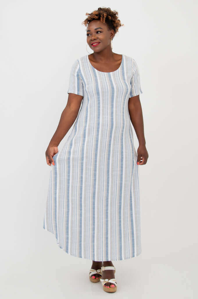 Front view of a woman modeling a striped, flowing maxi dress with pockets