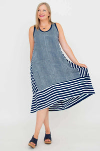 Woman modeling flowy navy and white striped hi-lo dress, showcasing side flair
