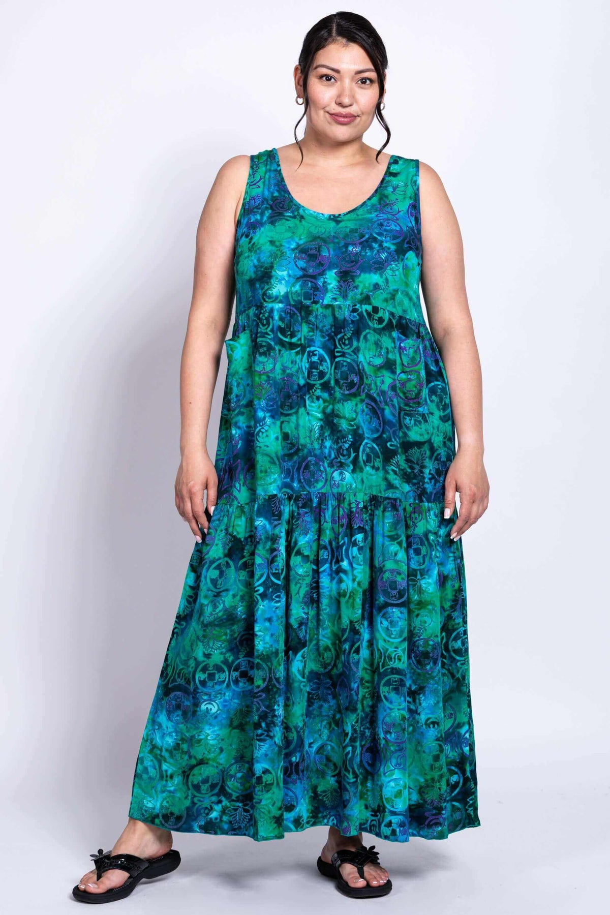 Woman modeling flowy blue-green maxi dress with relaxed fit, front view