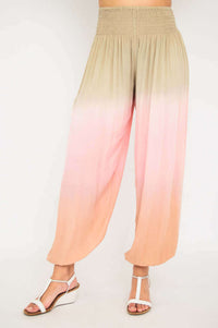 Flowy high-waisted ombre pants displayed from the front, gradient beige to pink to peach