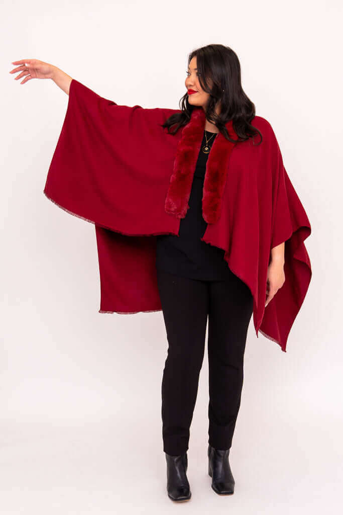 Woman with arm extended, displaying flowy design of scarlet wrap