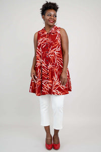 Woman facing forward wearing a ruby red bamboo print swing tank, smiling