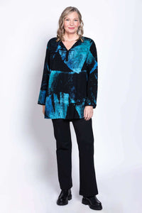 Woman facing forward in Kary Blouse showing full blue and black batik design over black trousers