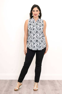 Front-facing view of floral sleeveless tank top paired with black pants