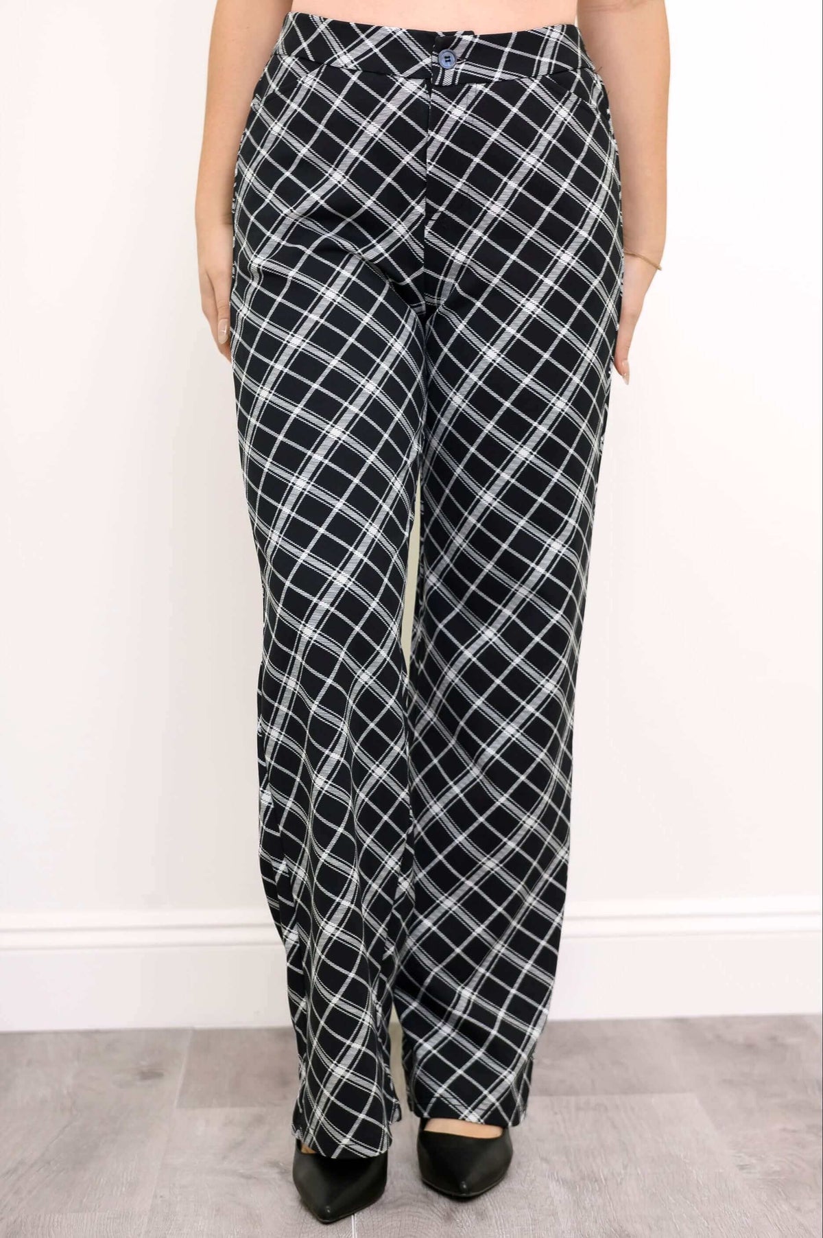 Front view of high-waisted black and white plaid trousers