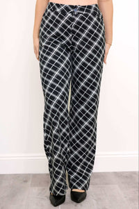 Front view of high-waisted black and white plaid trousers