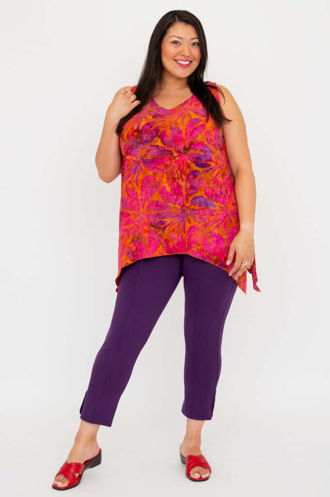 Model showing front angle of sleeveless tank top with bold orange and pink leaf print
