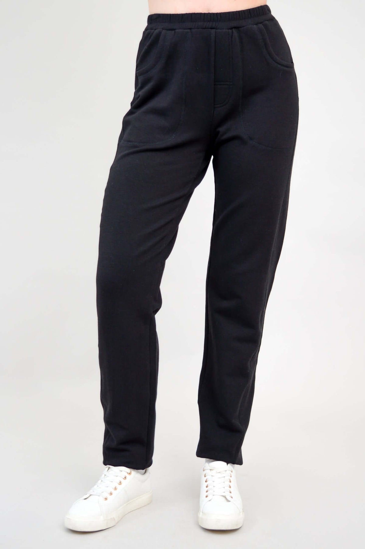 Front angled view of black bamboo fleece track pants with pockets and elastic waistband
