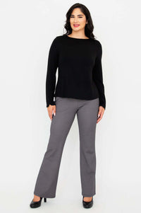 Woman posing in black long sleeve boat neck top and gray check pants, front angle