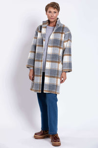 Front angled view of woman modeling plaid wool coat