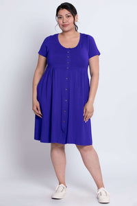 Front angled view of a model wearing a royal purple short sleeve dress with front buttons