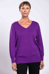 Front view close-up of model wearing purple V-neck cotton sweater