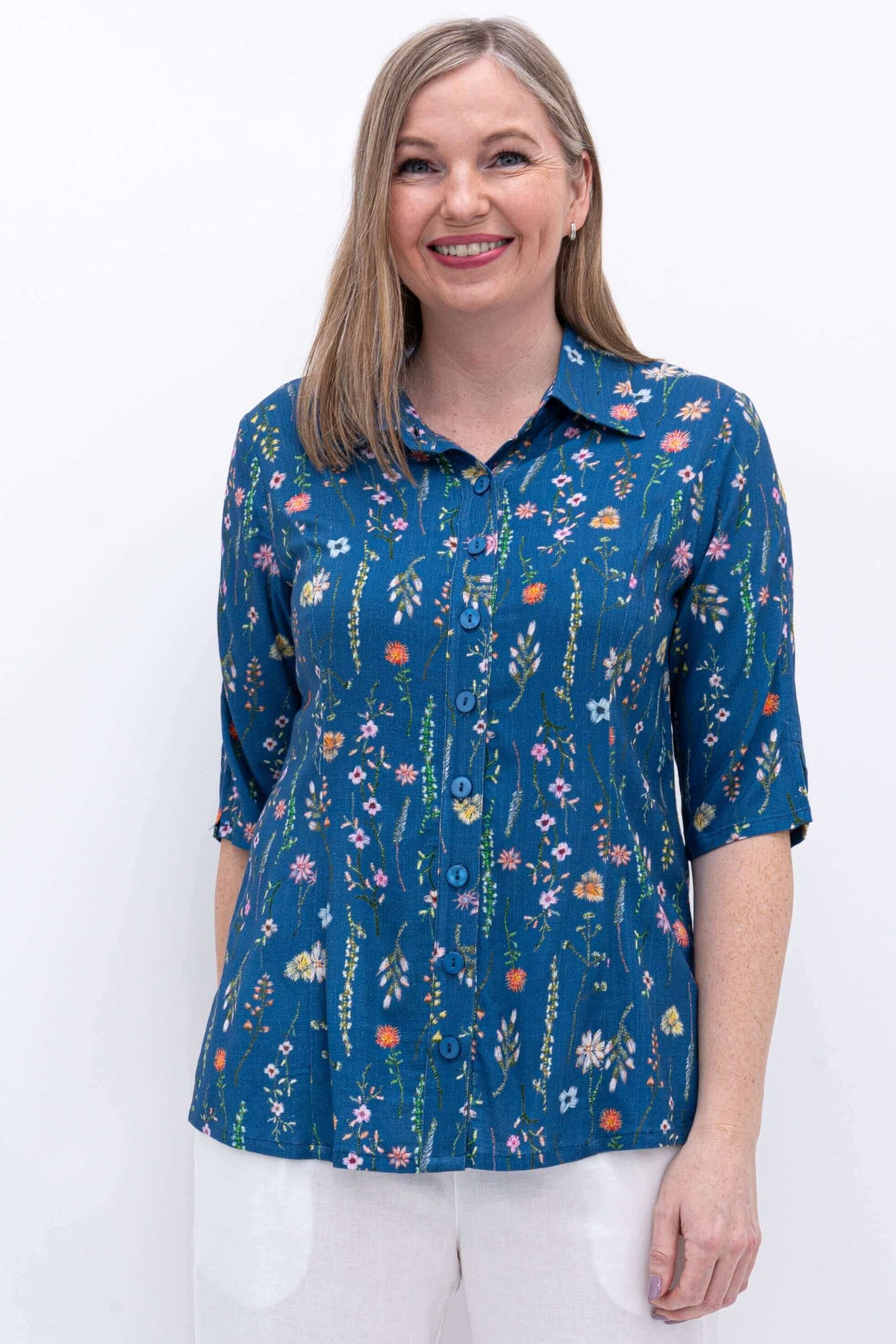 Front close-up of woman wearing blue floral bamboo linen blouse