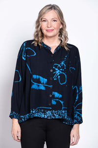 Front close-up of a woman wearing a navy blue batik print blouse with a mandarin collar